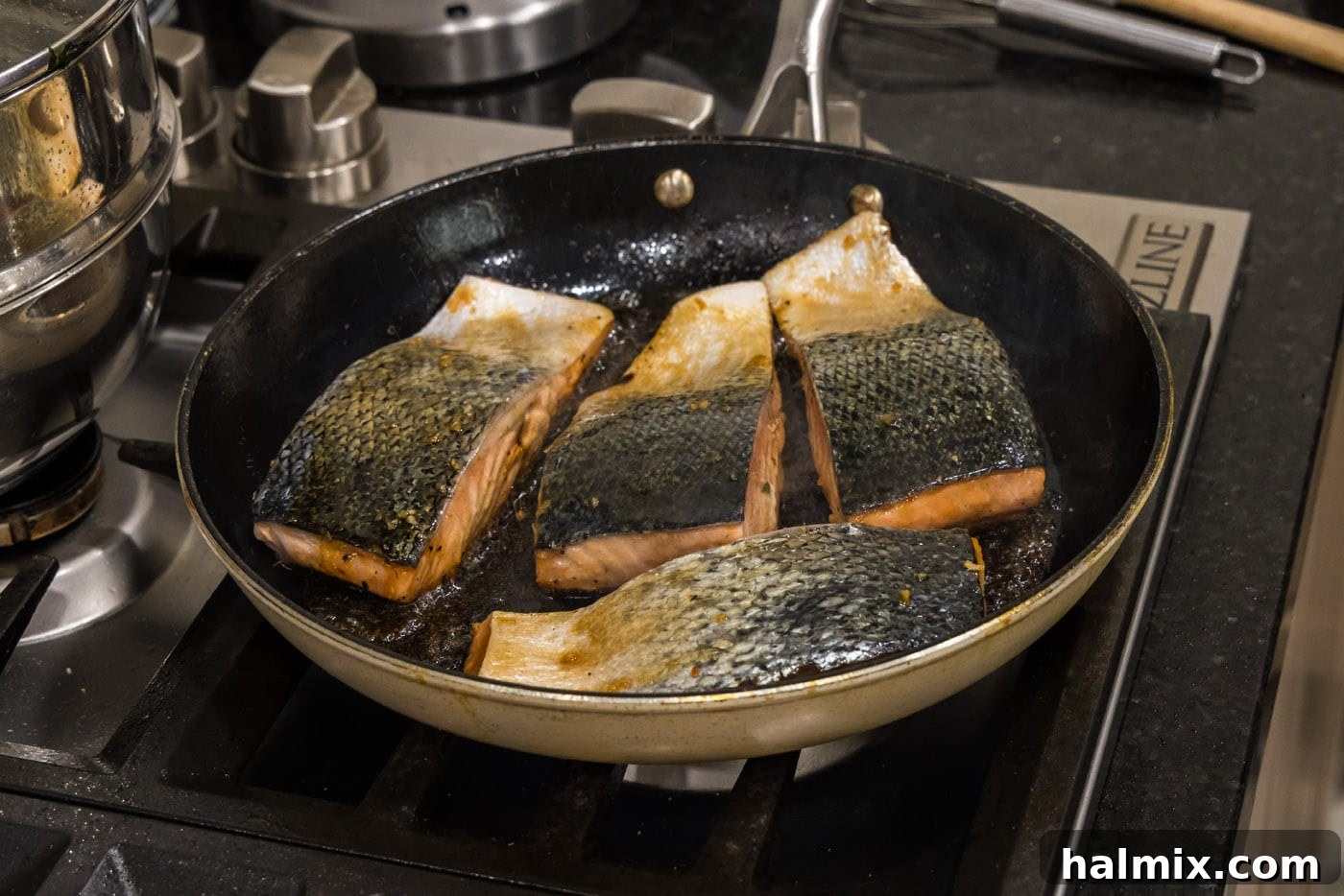 Searing salmon fillets flesh side up in a hot skillet for the honey glazed salmon.
