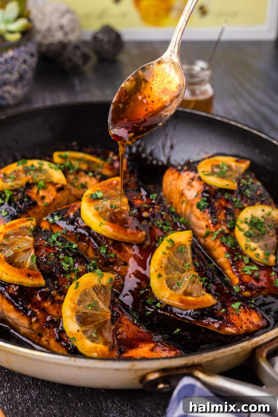 Honey Salmon sauce being drizzled over a cooked fillet, showing the sticky glaze.