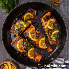 Close up photo of Honey Salmon in a skillet, glistening with glaze.
