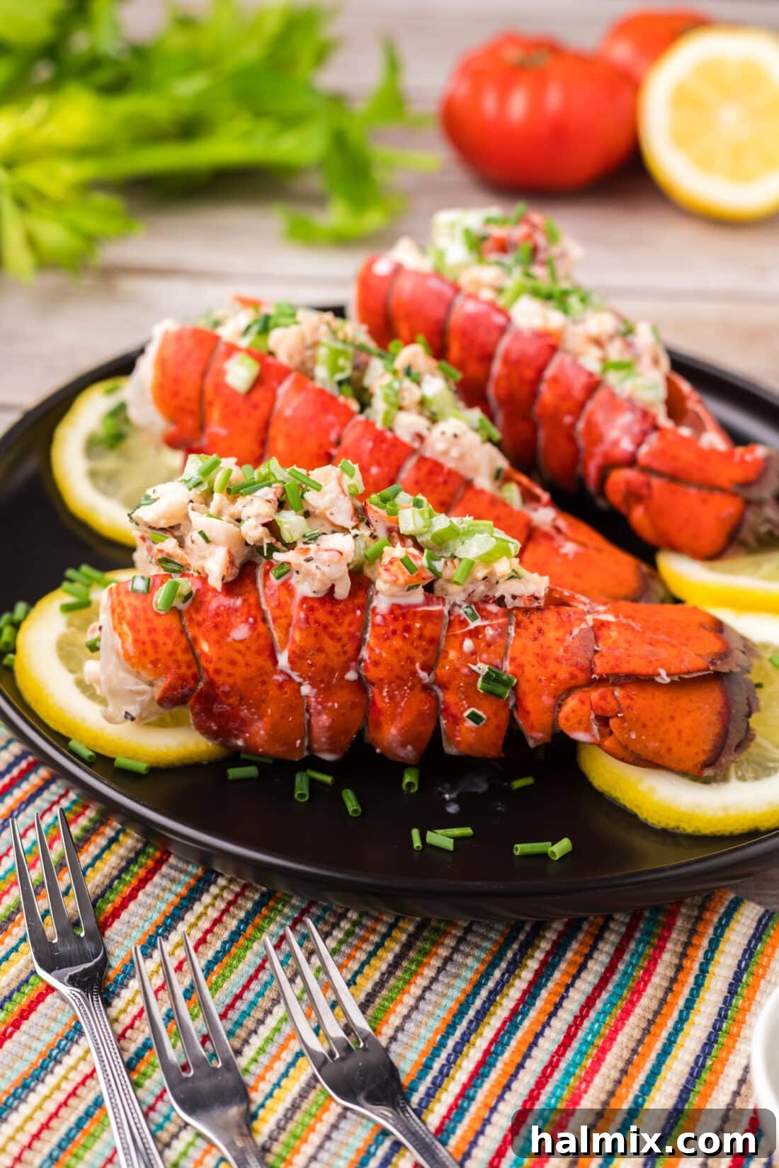 Garnished lobster salad elegantly presented in lobster tails on a serving platter, showcasing its vibrant colors and luxurious texture.
