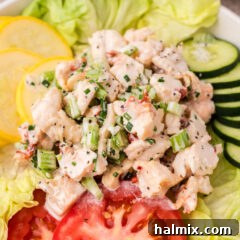 Close up photo of creamy lobster salad garnished with fresh chives, ready to be served.