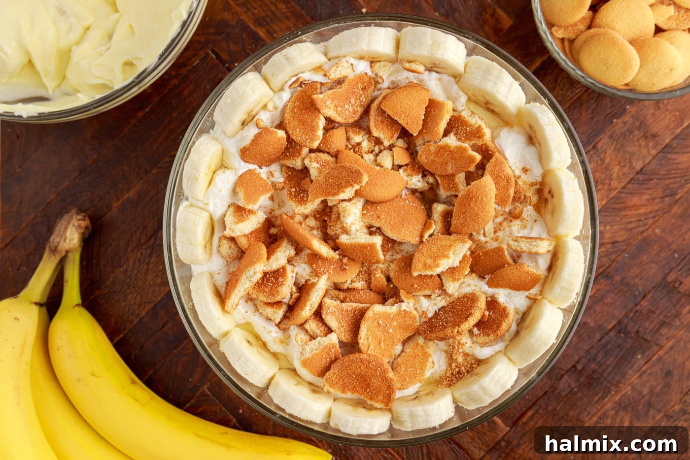 Adding a decorative ring of sliced bananas around the inside of a trifle bowl.