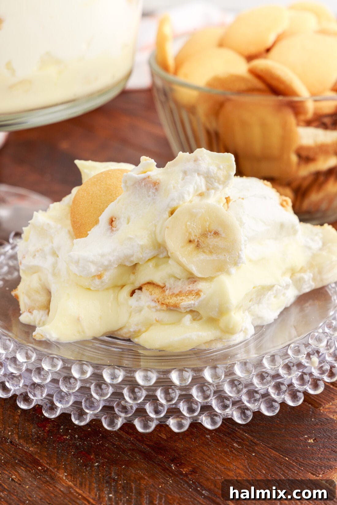 A slice of Banana Trifle served on a plate, showing the distinct layers.