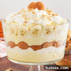 A beautifully presented Banana Trifle in a glass bowl.