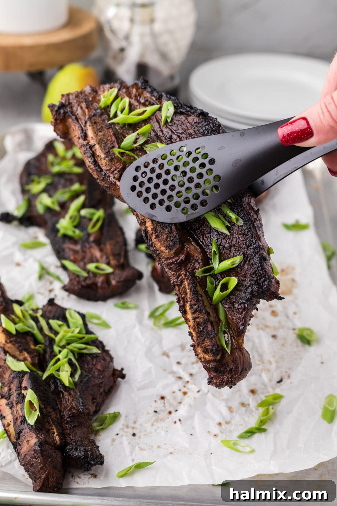 Tongs holding up a Korean Short Rib