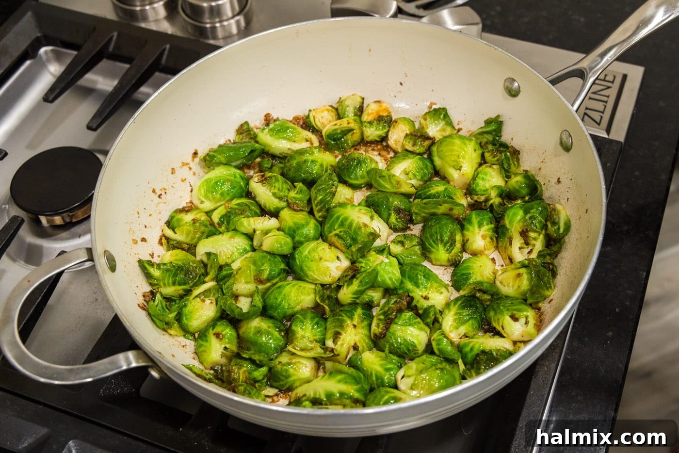 brussel sprouts cooking in a skillet, cut side down for caramelization