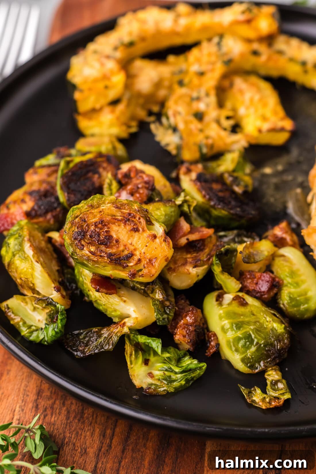 Brussels Sprouts with Bacon, Shallots and Candied Pecans on a plate with Air Fryer Acorn Squash, showcasing a complete meal
