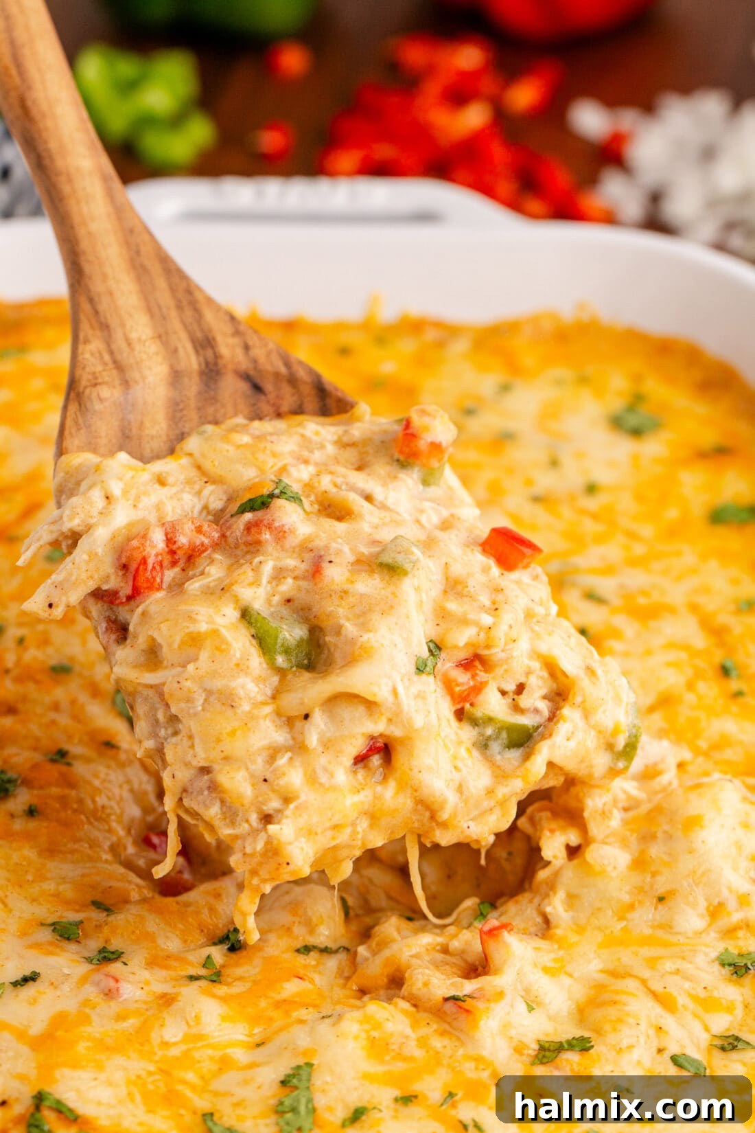 Hearty King Ranch Chicken Bake 2 A serving of King Ranch Chicken Casserole being lifted from a baking dish with a spatula, showing its cheesy, layered goodness.