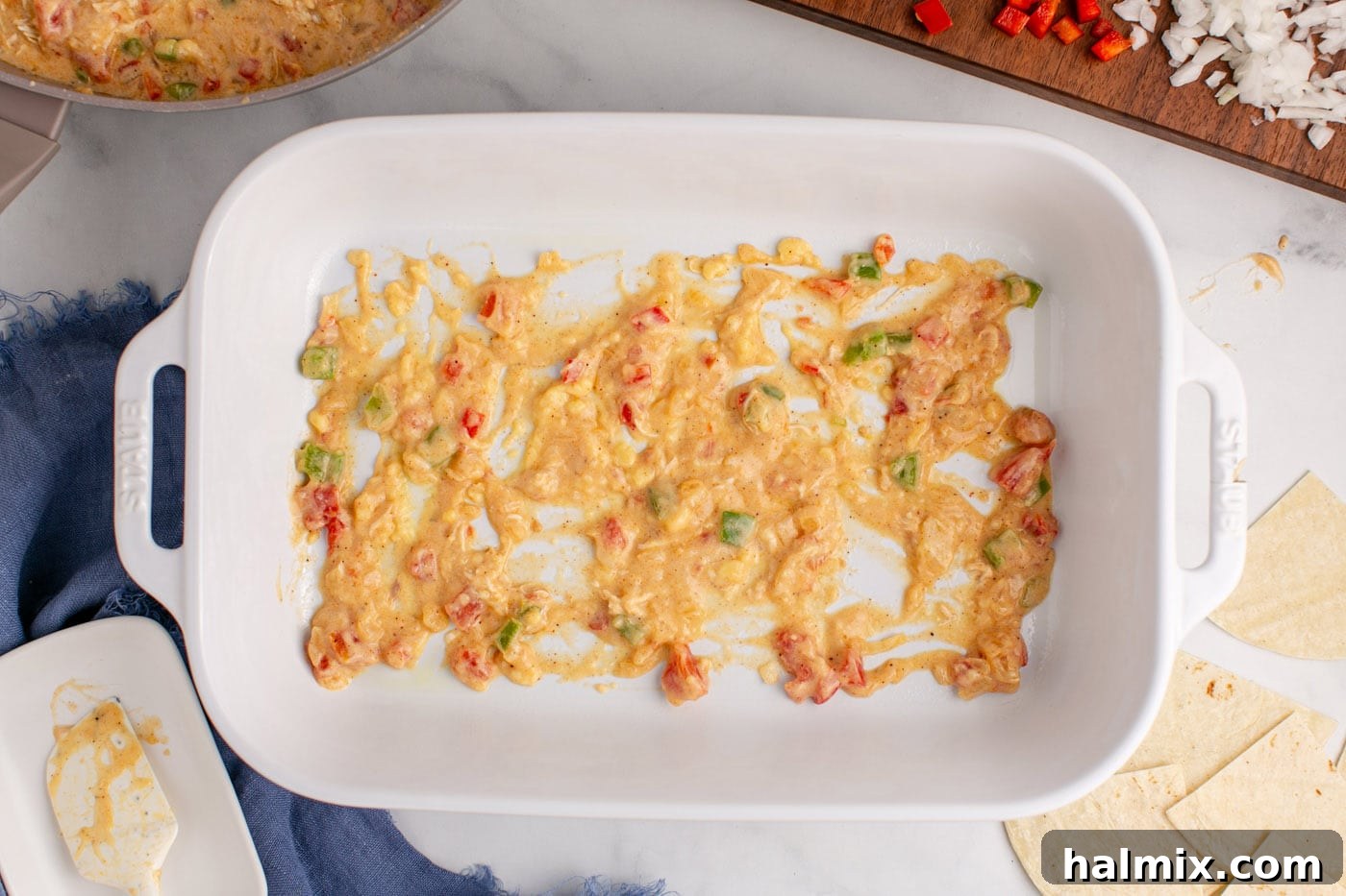 Hearty King Ranch Chicken Bake 11 A layer of creamy sauce mixture spread evenly on the bottom of a baking dish.