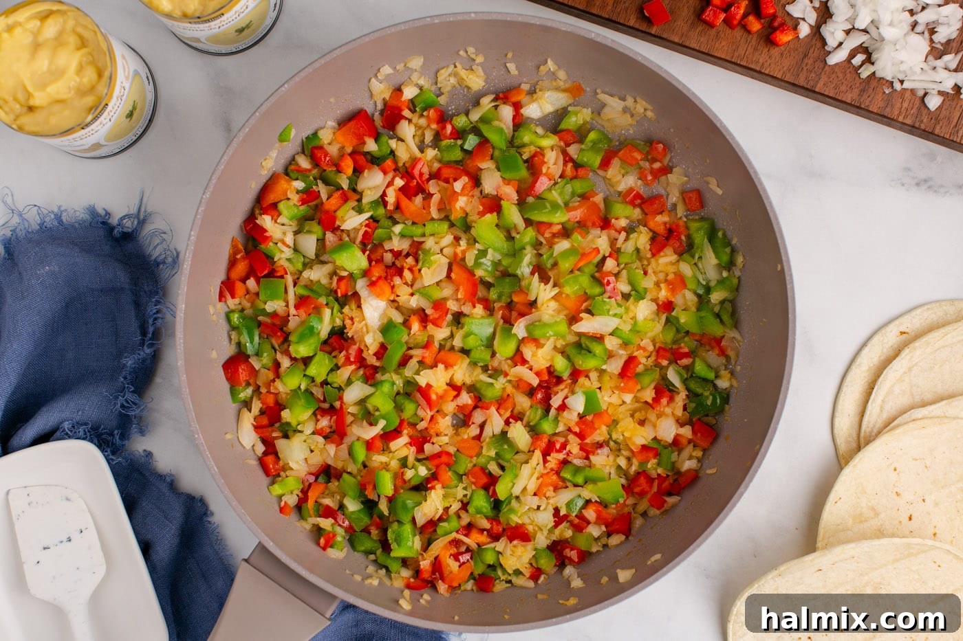 Hearty King Ranch Chicken Bake 6 Sautéed bell peppers and onion looking vibrant and tender in a skillet.