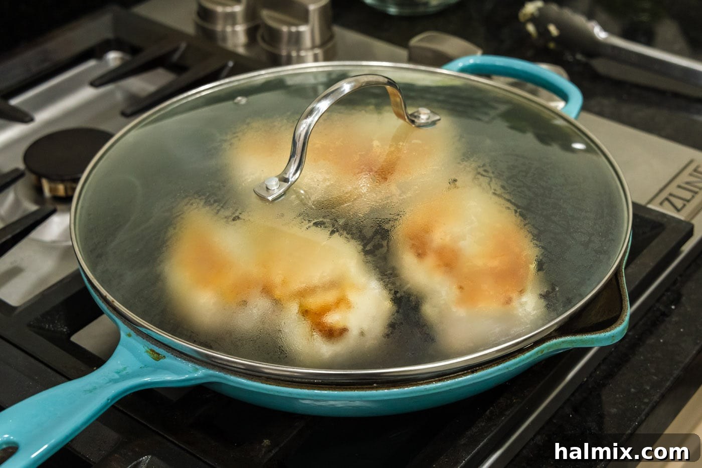 Lid on skillet to help chicken breasts cook through