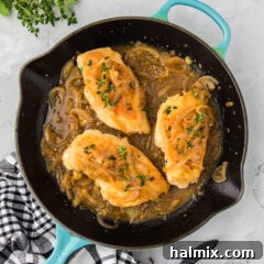 Chicken with Onion Thyme Sauce in a skillet, showcasing the rich, golden-brown chicken and savory sauce.