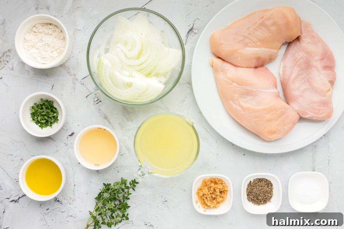 A collection of fresh ingredients laid out for Chicken with Onion Thyme Sauce, including chicken, onions, garlic, thyme, and various liquids.