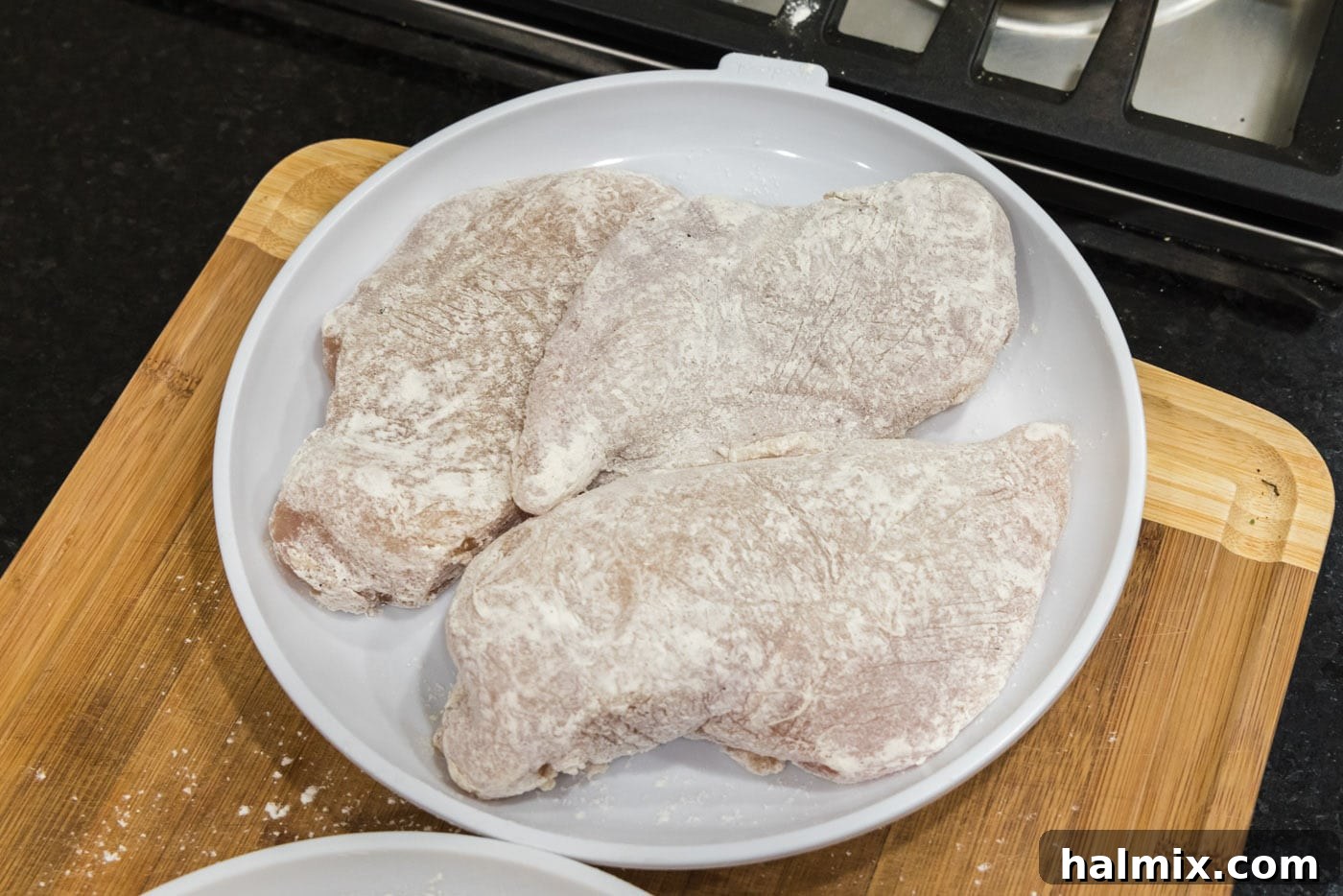 Flour coated chicken breasts ready for searing