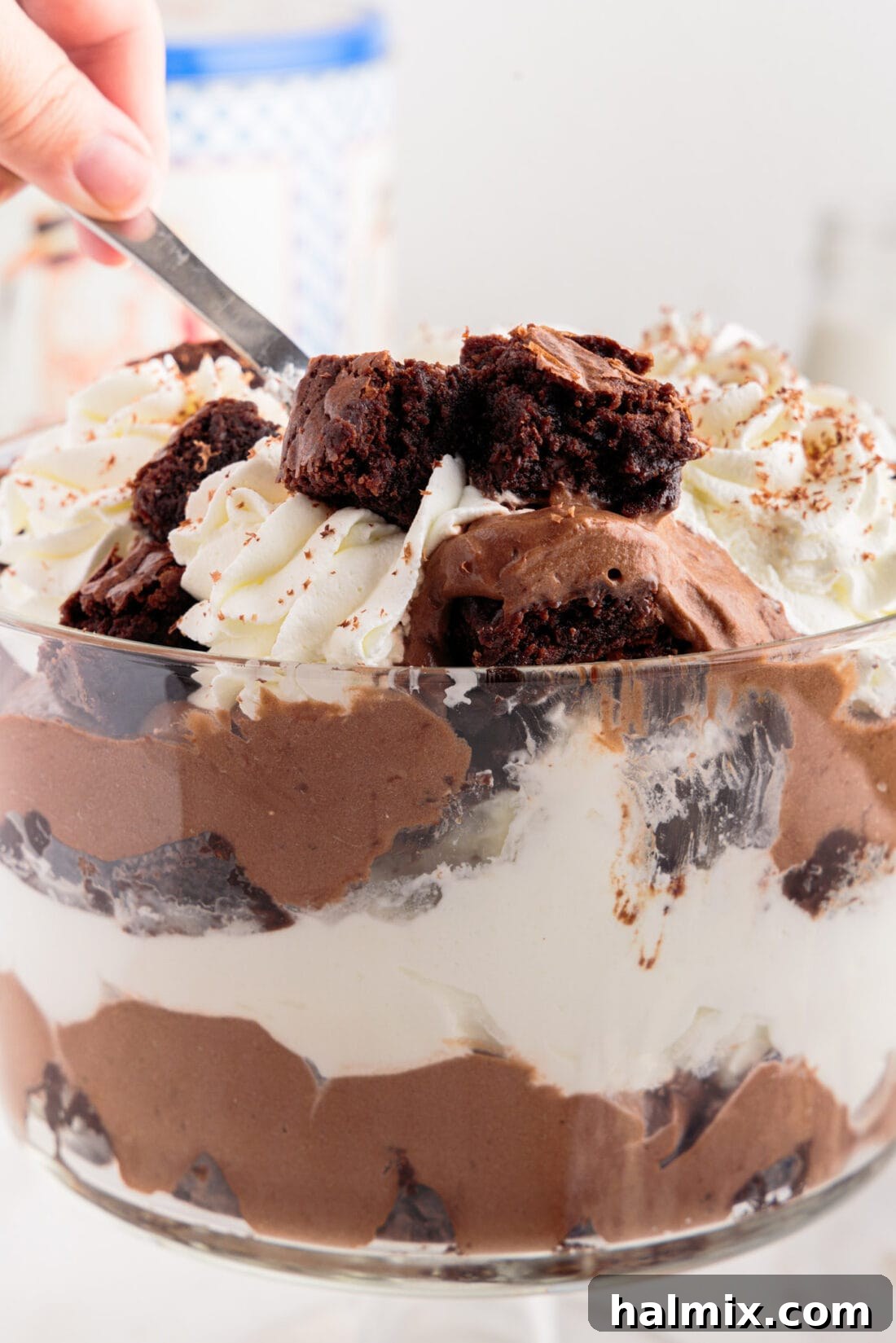 Ultimate Fudge Brownie Trifle 3 Spoon digging into a layered Brownie Trifle, showing the texture of each layer