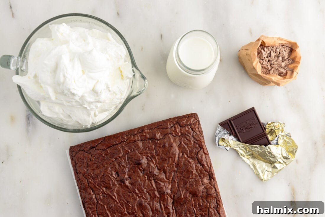 Ultimate Fudge Brownie Trifle 4 Ingredients laid out for a Brownie Trifle, including brownie mix, milk, pudding mix, heavy cream, and chocolate bar