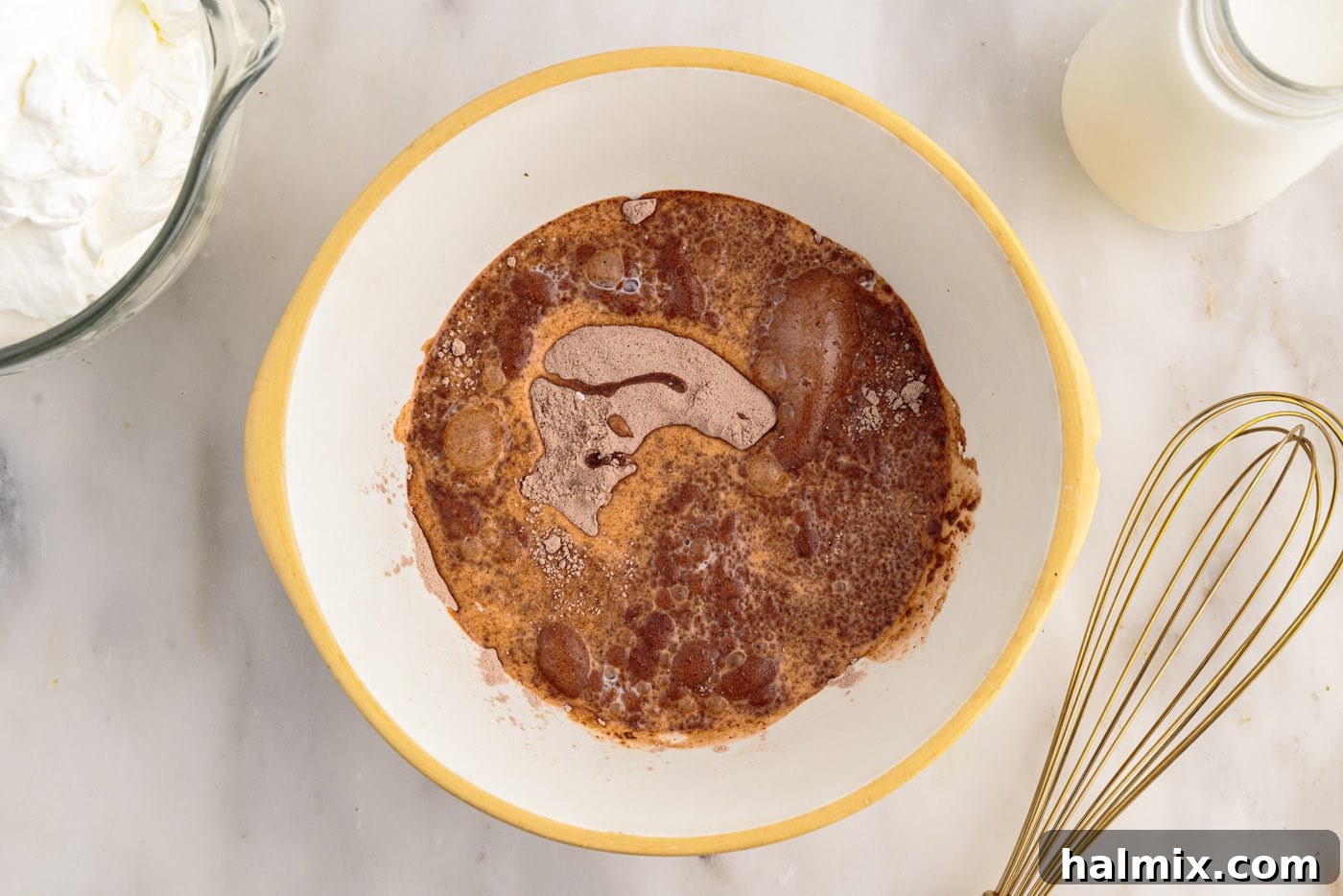 Ultimate Fudge Brownie Trifle 6 Measuring milk into a mixing bowl for the chocolate pudding layer