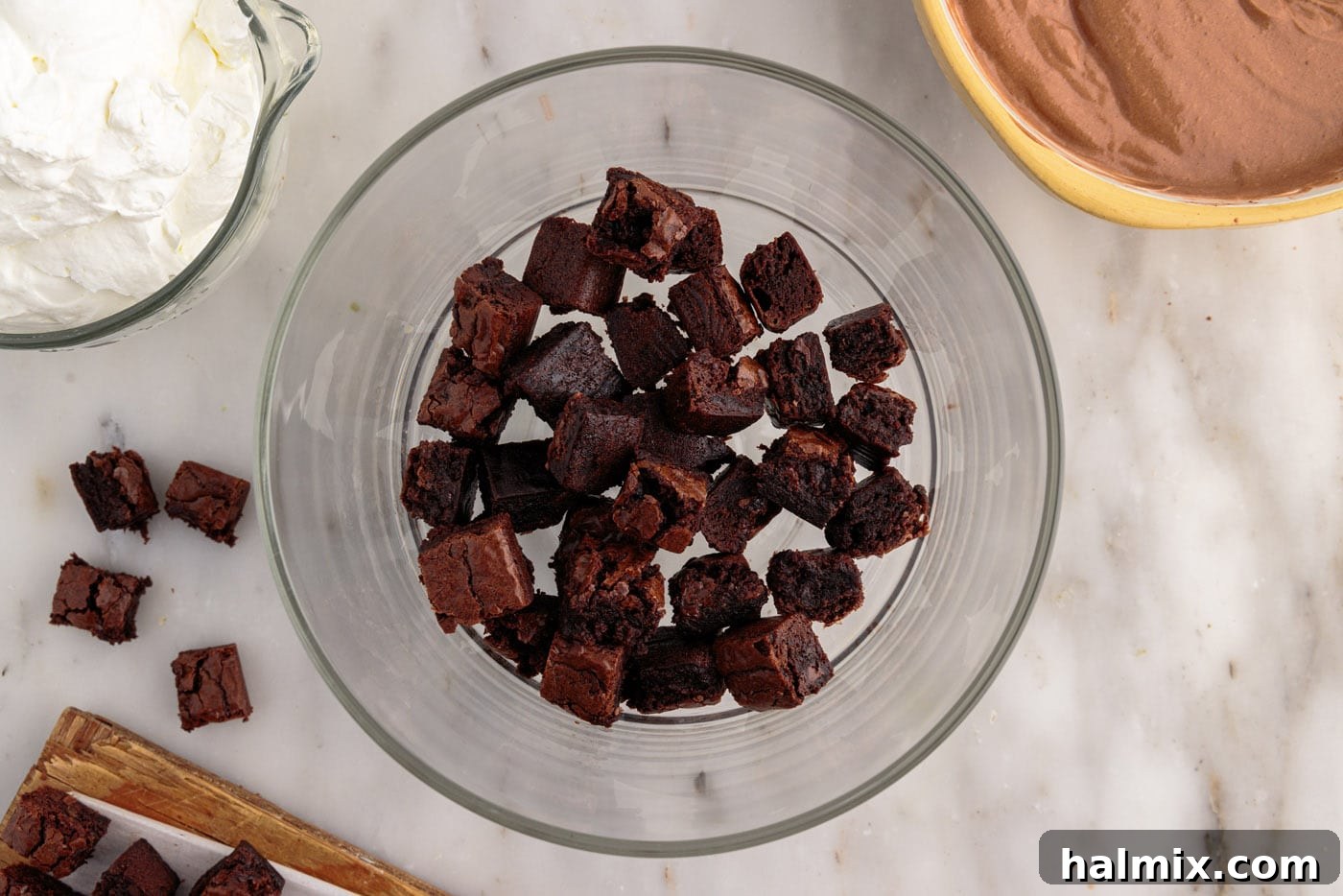 Ultimate Fudge Brownie Trifle 10 First layer of brownie chunks placed evenly at the bottom of a clear trifle bowl