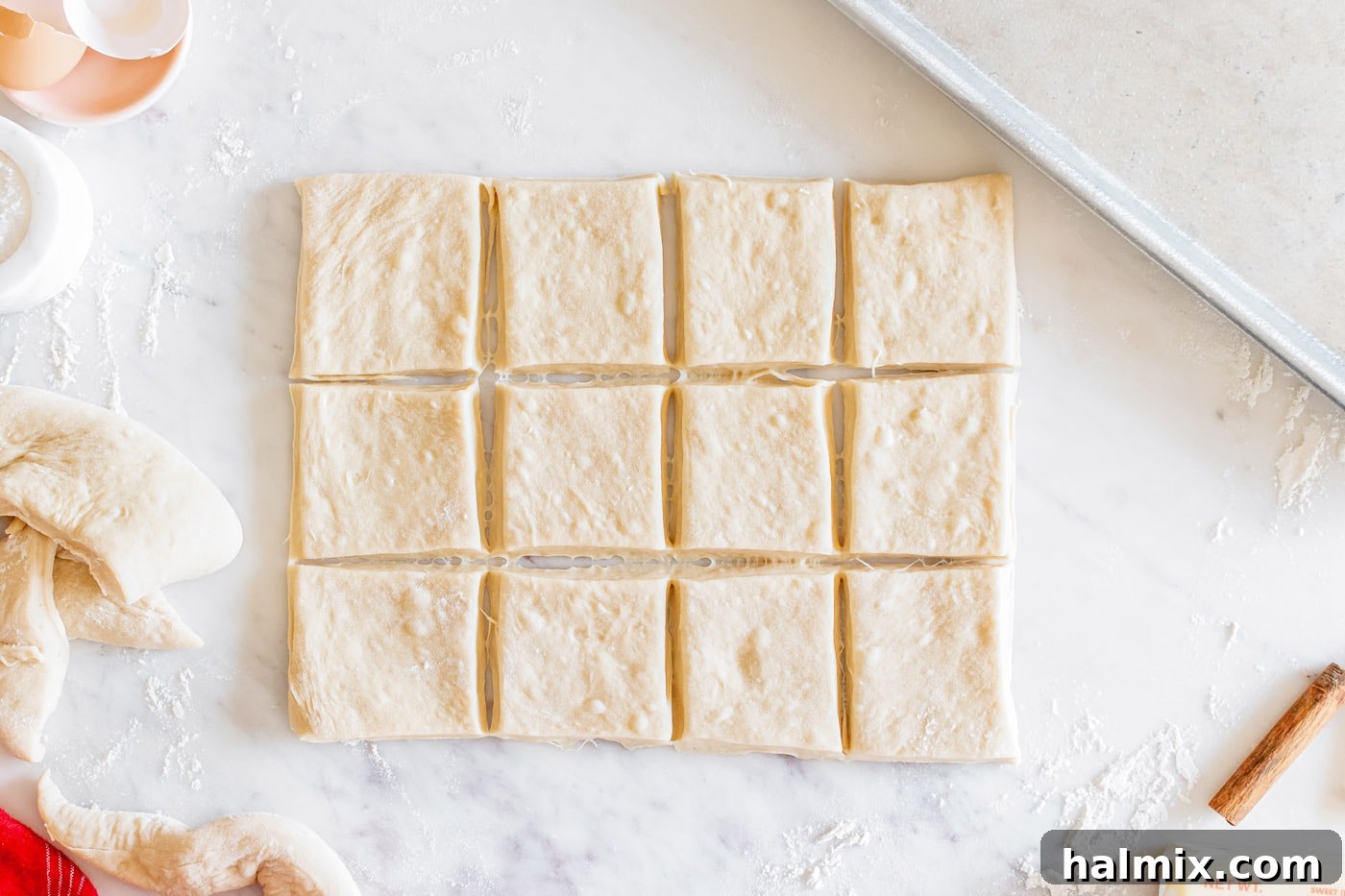Rolled dough neatly cut into square pieces, ready for the baking sheet.