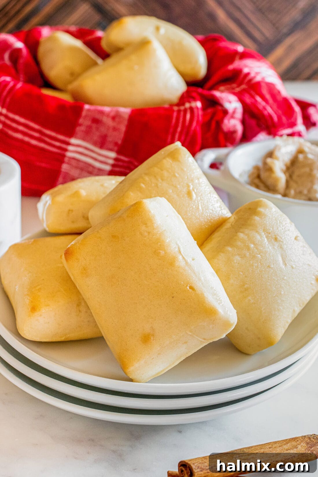 Freshly baked Texas Roadhouse Rolls neatly arranged on a white plate, ready for serving.