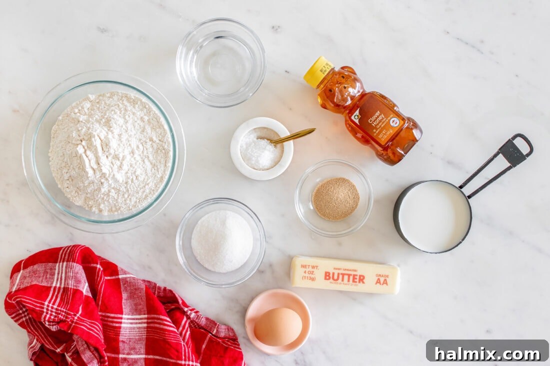 A collection of ingredients laid out on a counter, prepared for making Texas Roadhouse Rolls.