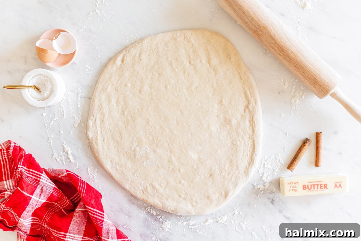 Dough rolled flat into a large rectangle on a lightly floured surface.