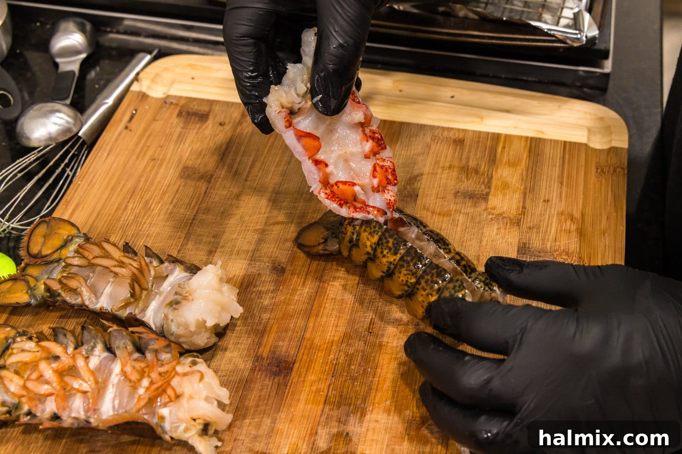 hand pulling lobster meat out of shell