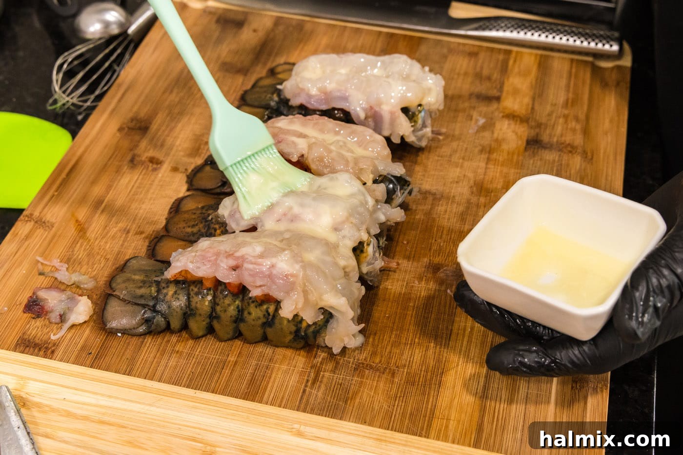 brushing crowned lobsters with melted butter