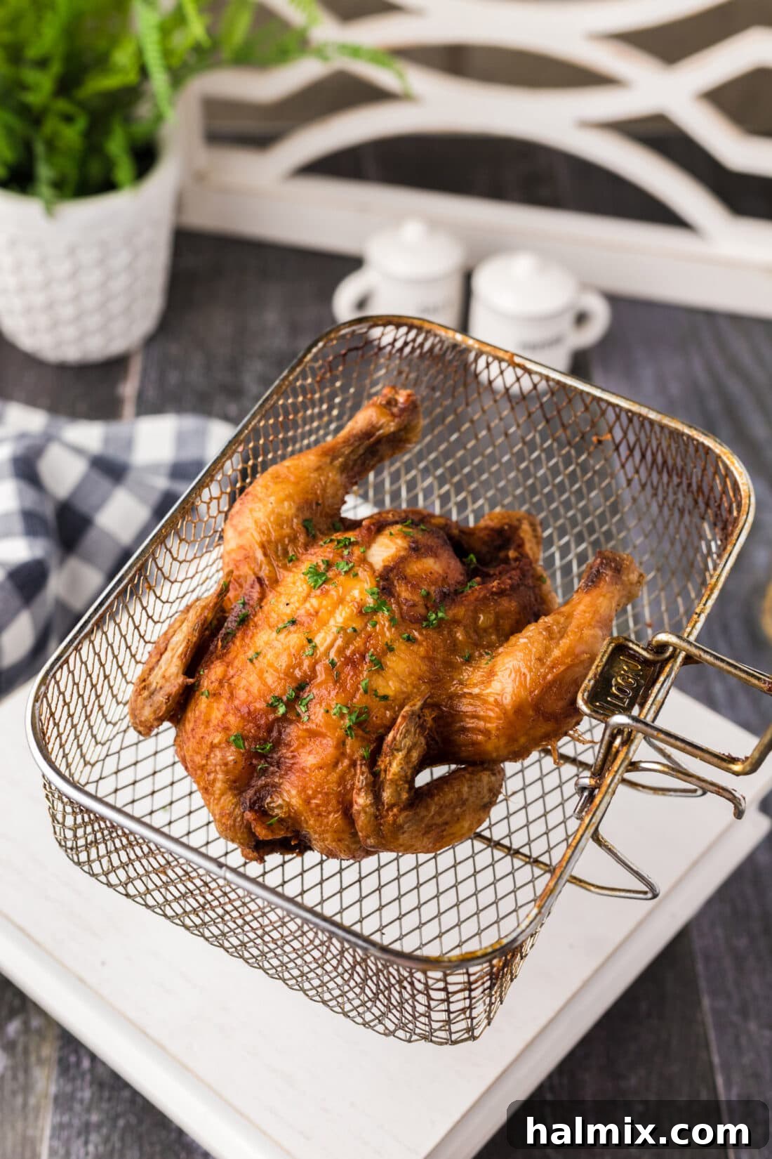 Deep Fried Cornish Hen in a deep fryer basket