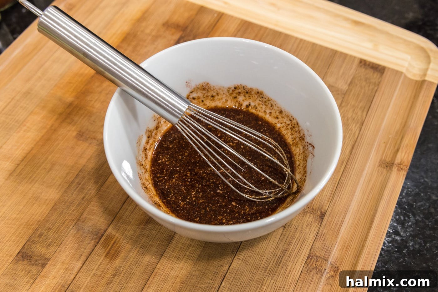 cornish hen wet rub with a whisk in a bowl
