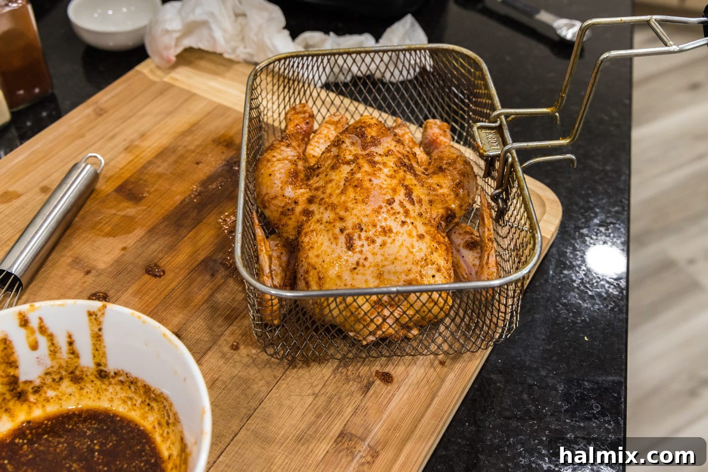 cornish hen in a deep fryer basket