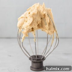 Peanut Butter Frosting on a whisk attachment, showcasing its fluffy texture
