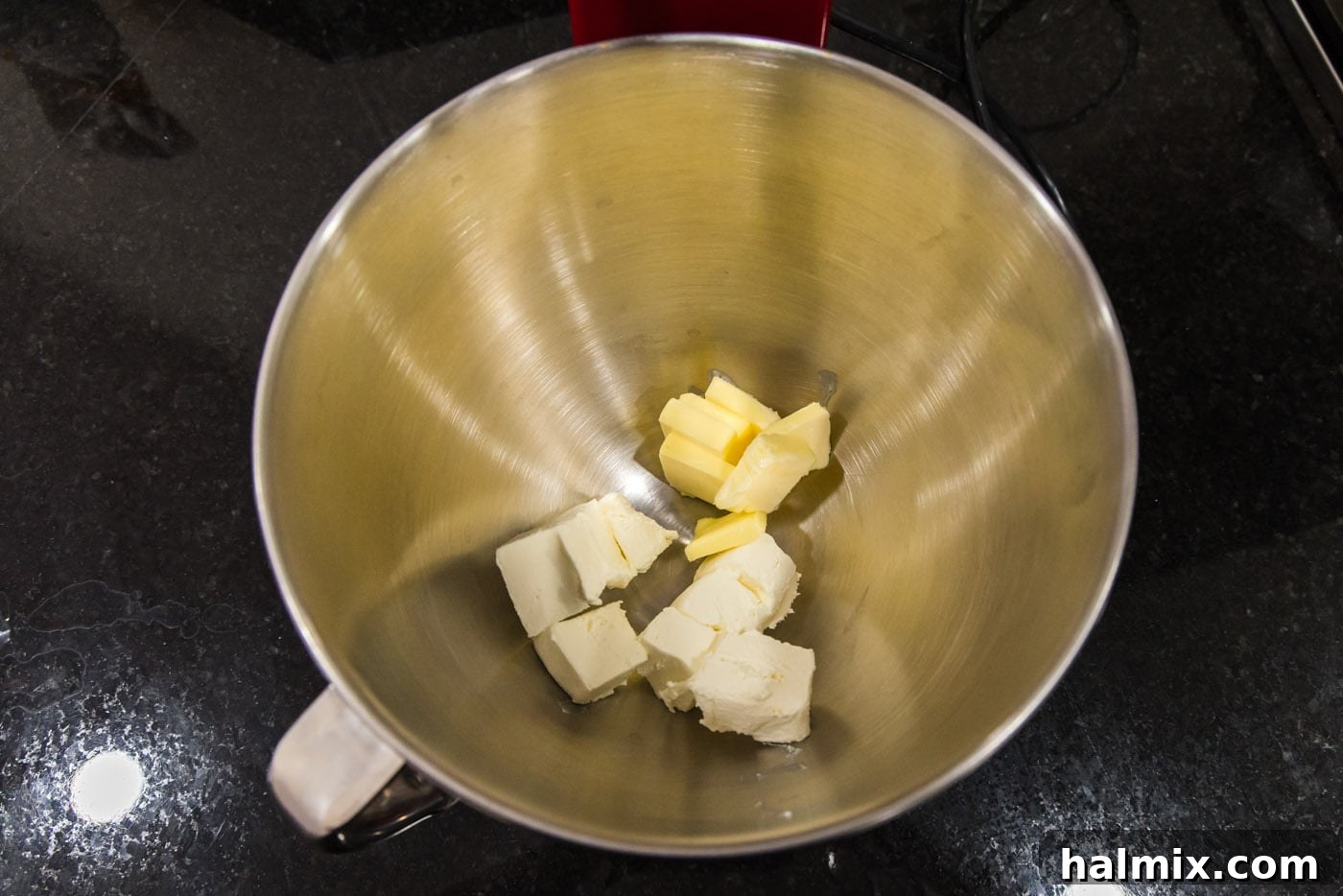 Softened butter and cream cheese in the bowl of a stand mixer, ready to be beaten