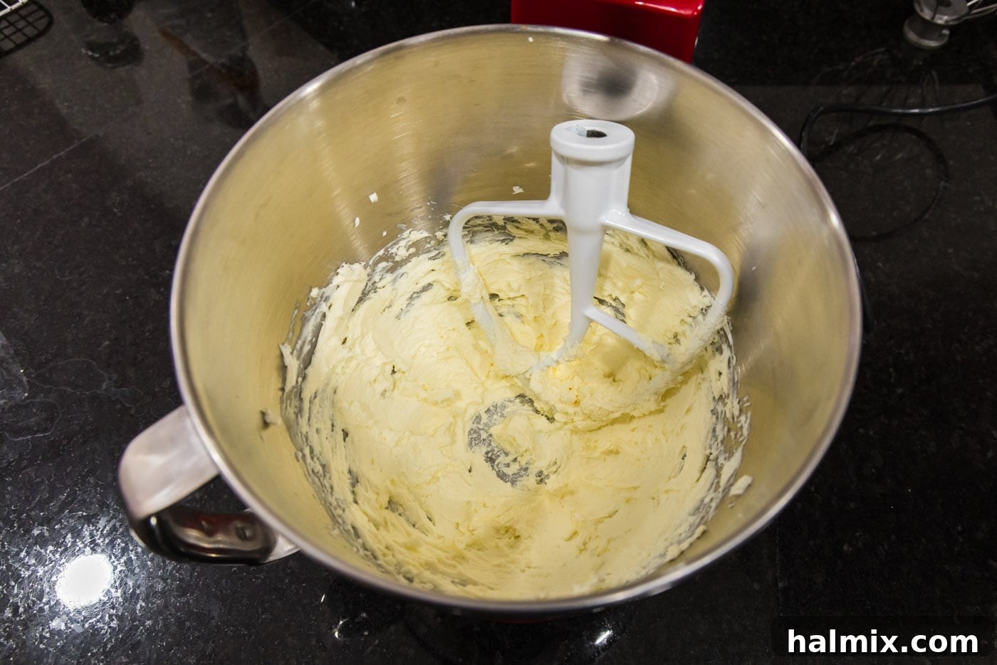 Butter and cream cheese perfectly creamed together in a stand mixer, showcasing a smooth texture