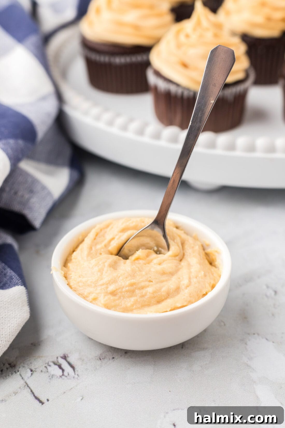 A bowl overflowing with smooth and creamy Peanut Butter Frosting