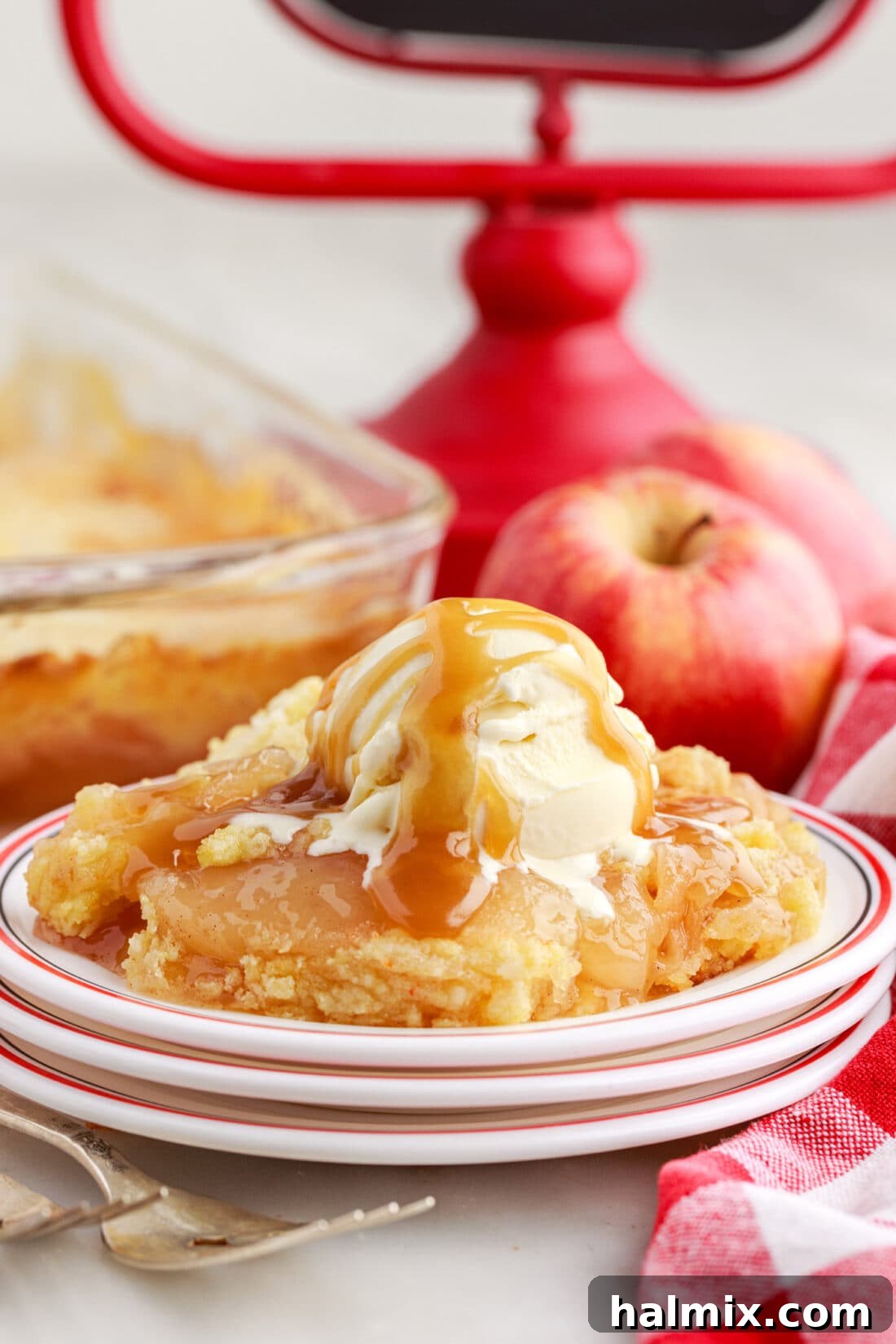 Apple Dump Cake on a plate toped with ice cream and caramel