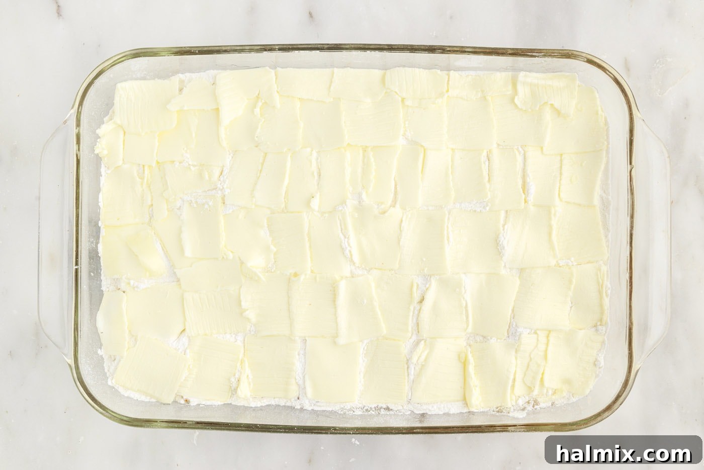 thin pats of butter over the top of cake mix and apple pie filling