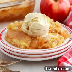 Apple Dump Cake on a plate topped with a scoop of ice cream
