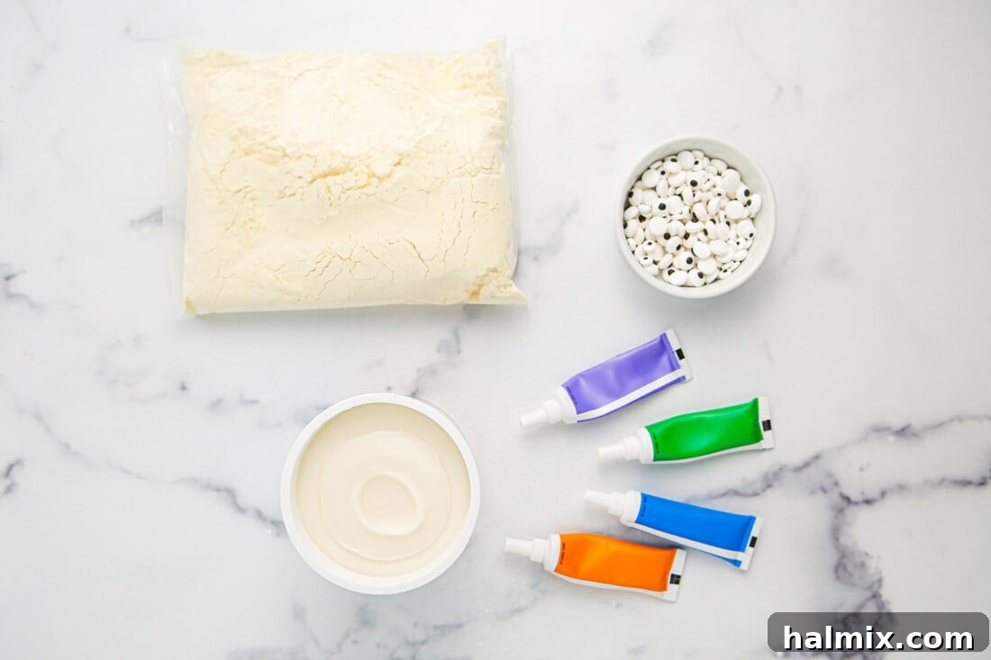 Ingredients for Monster Cupcakes laid out, including cake mix, frosting, food coloring, and candy eyeballs