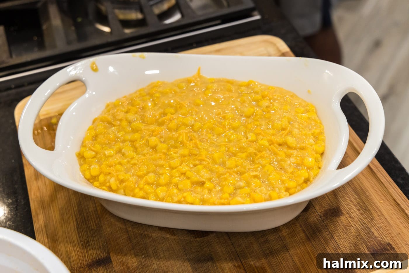 Golden Comfort Corn Bake 11 The fully mixed scalloped corn casserole ingredients poured into a baking dish, ready for the final touches.