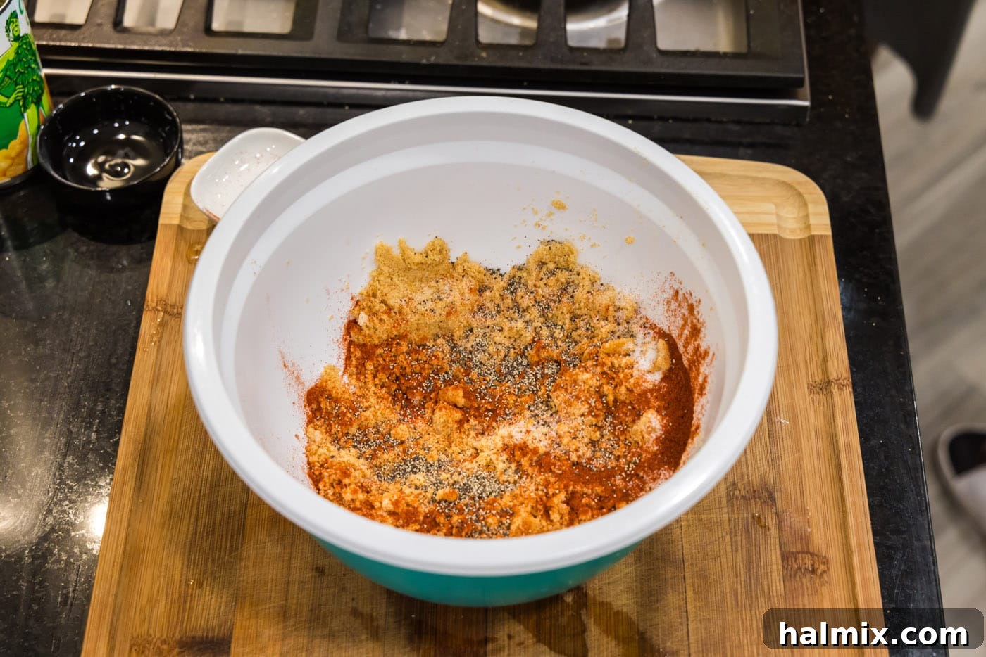 Golden Comfort Corn Bake 13 Paprika, salt, and pepper being added to the remaining crushed Ritz cracker topping, ready for seasoning.
