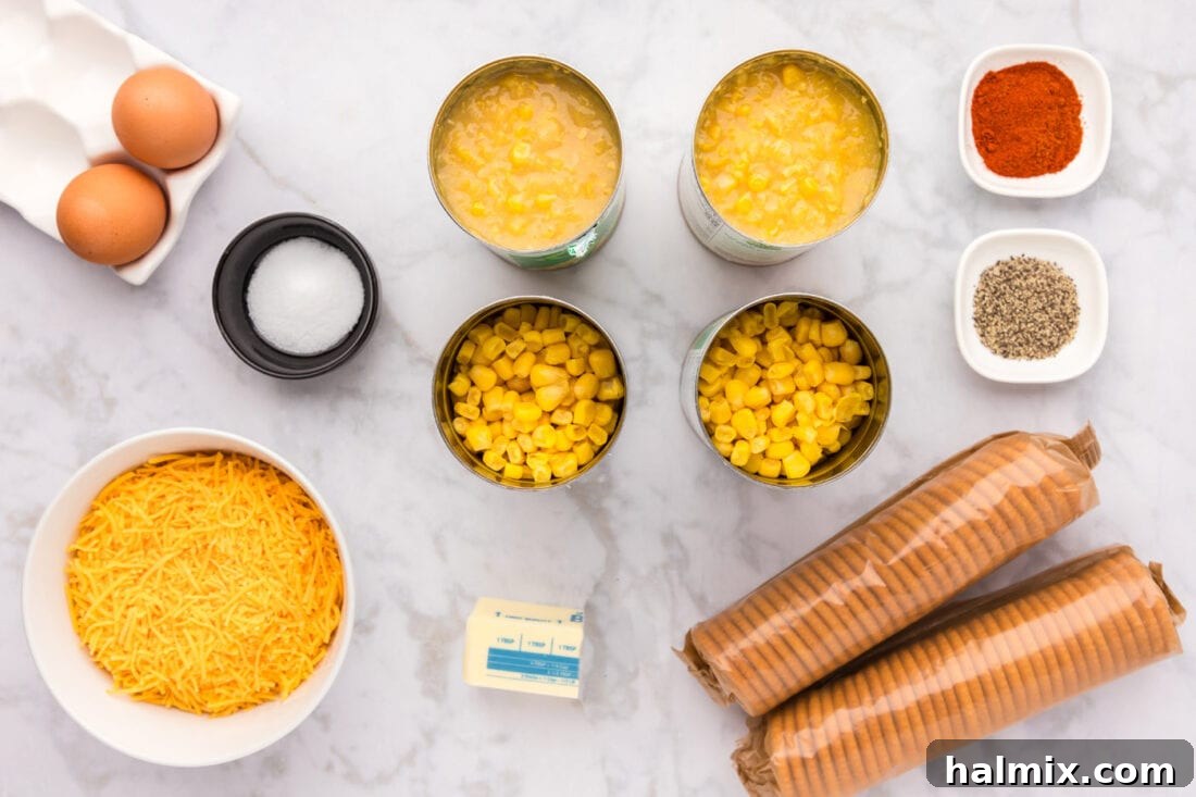 Golden Comfort Corn Bake 4 A flat lay photograph showcasing all the fresh ingredients needed for making Scalloped Corn, including cans of corn, cheese, butter, crackers, and spices.