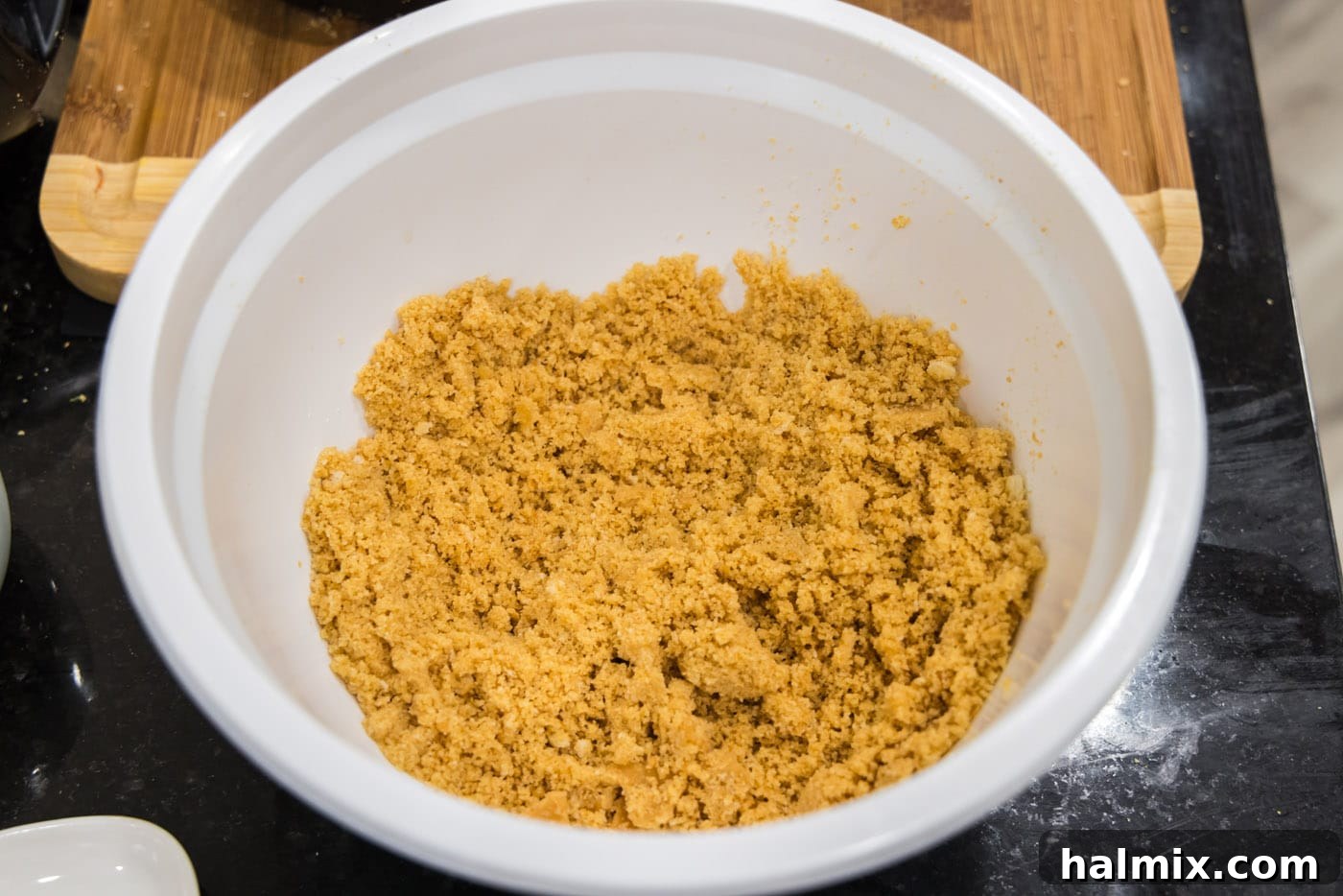 Golden Comfort Corn Bake 7 The buttery Ritz cracker topping in a bowl, prepared and ready to be added to the scalloped corn casserole.