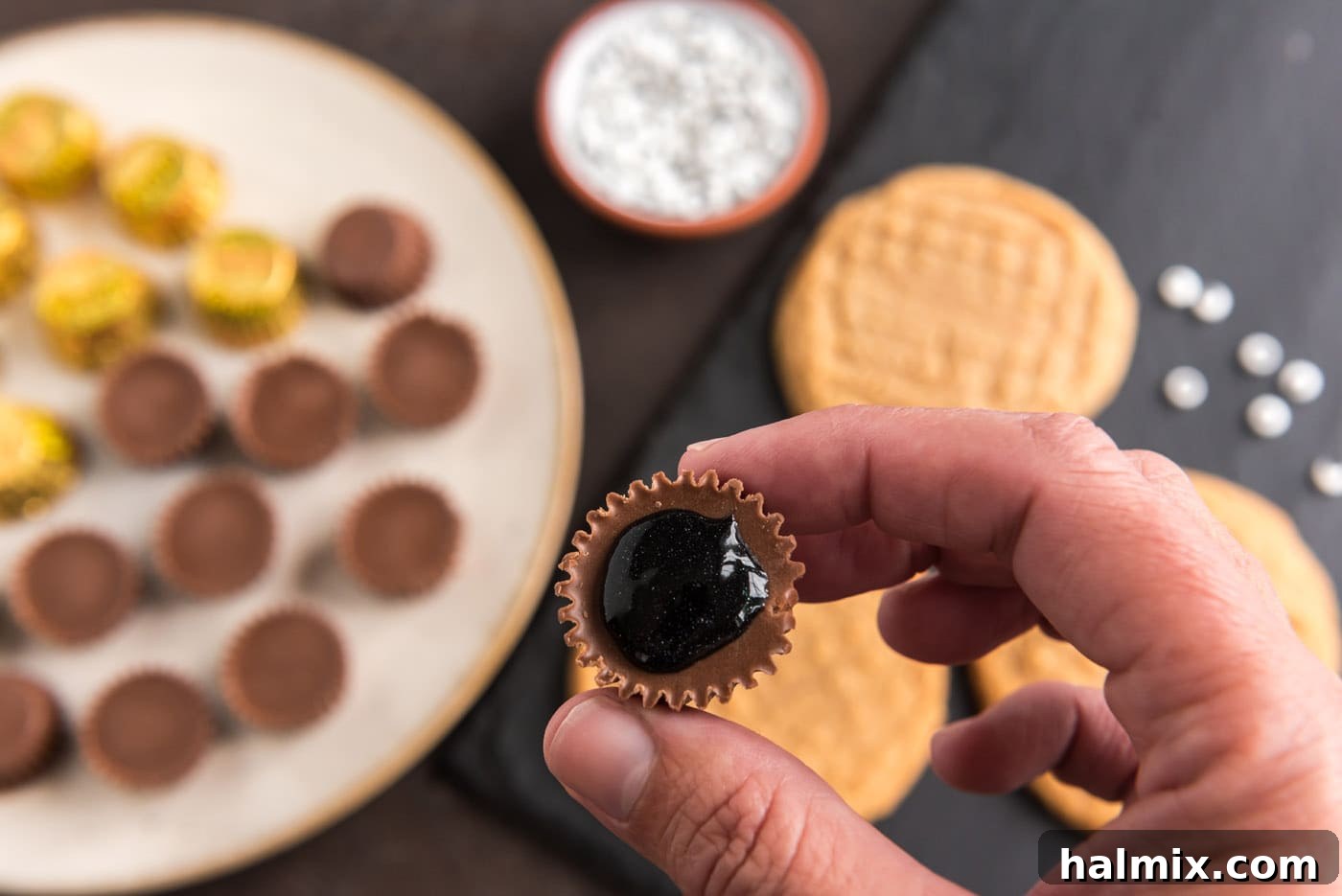 black decorator gel on the bottom of a reeses peanut butter cup