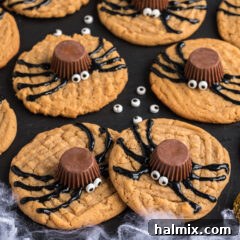 Spider Cookies on a black platter with candy eyes scattered around