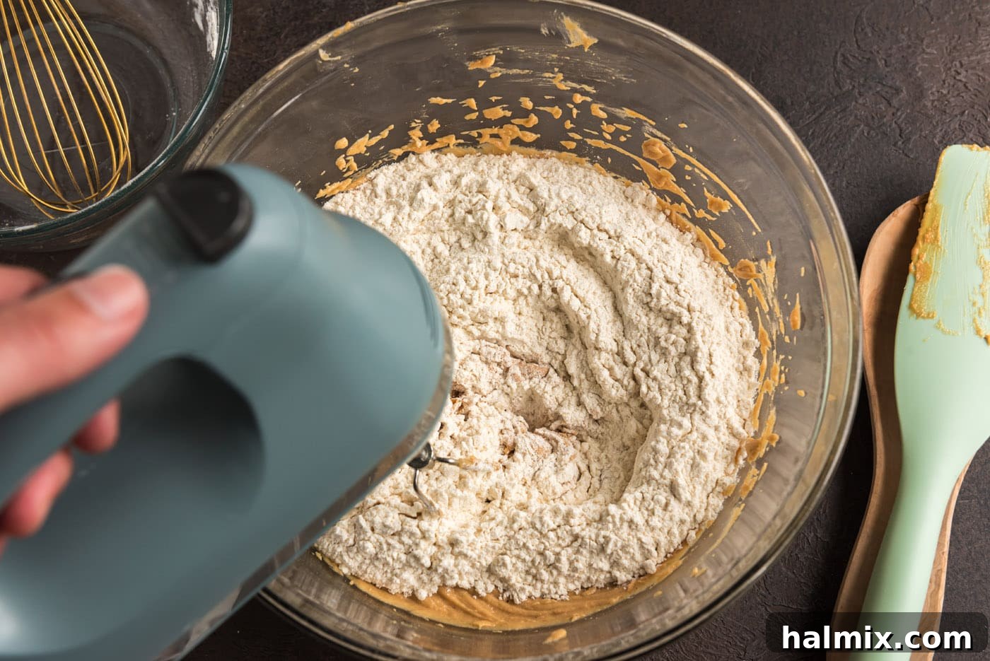 adding dry ingredients to wet ingredients for cookie dough