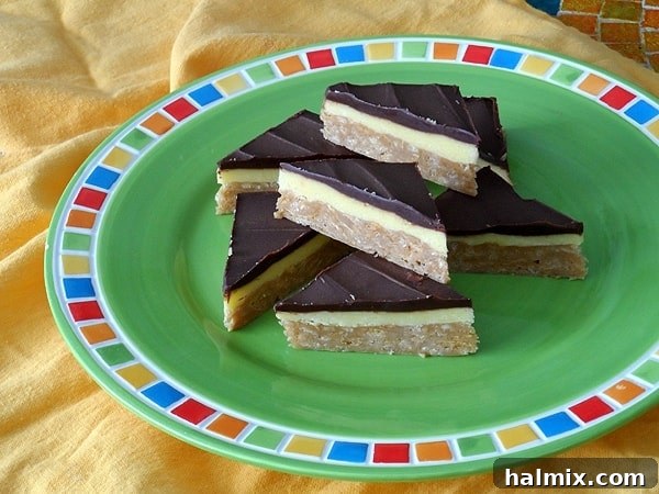 A close-up photo of deliciously layered no-bake peanut butter pudding bars resting on a vibrant green plate, showcasing their inviting appearance.