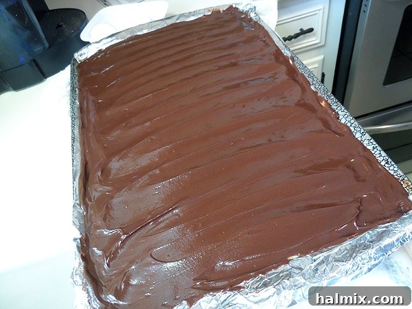 A shot showcasing the three complete layers of the no-bake peanut butter pudding bars in the pan, prior to chilling.