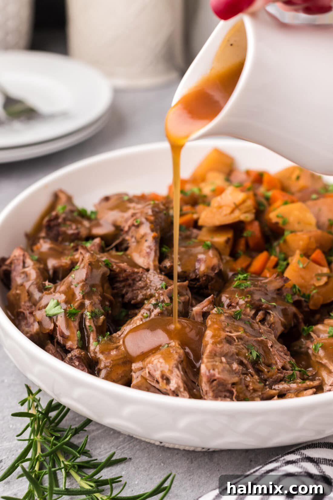 Gravy being poured over Instant Pot Roast Beef 