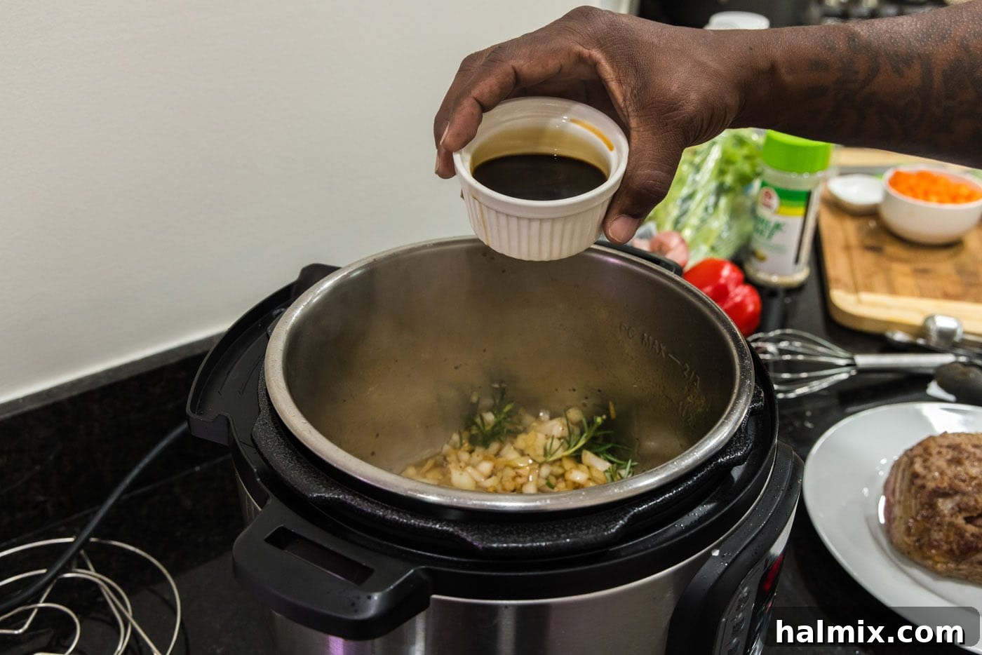 pouring soy sauce into instant pot with onion mixture